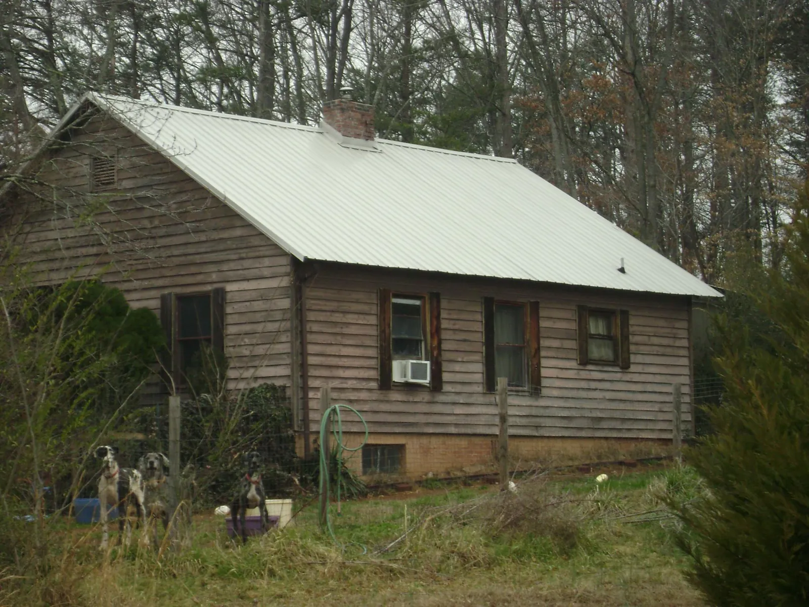 White metal roof on an old wood sided farmhouse, from a Metal Roof Installation job in Minneota